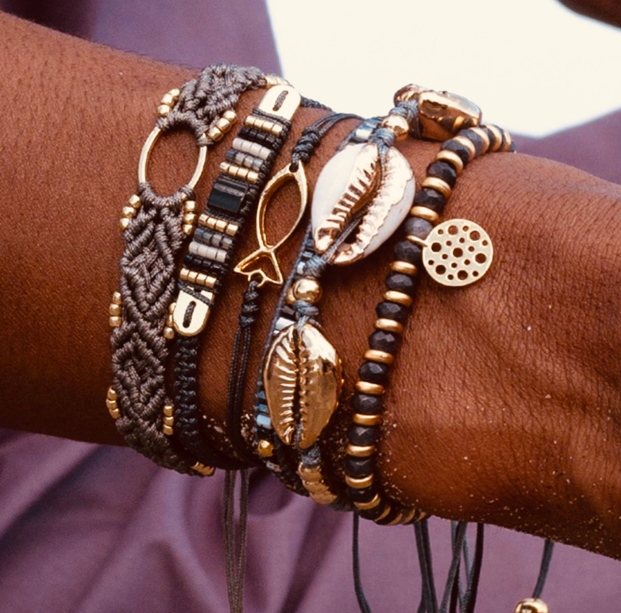  Hide and Chic's Bracelet Stacks diverse collection of bracelets featuring precious stones, metals, and charms