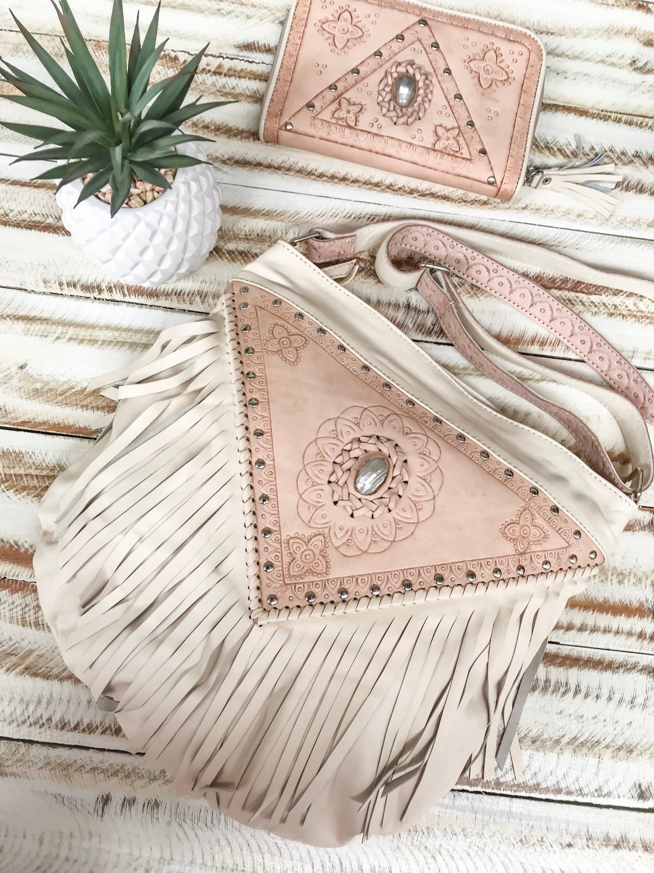 Image of the Aurora Fringed Bag, featuring cream leather with detailed fringing, showcasing its boho-chic design.