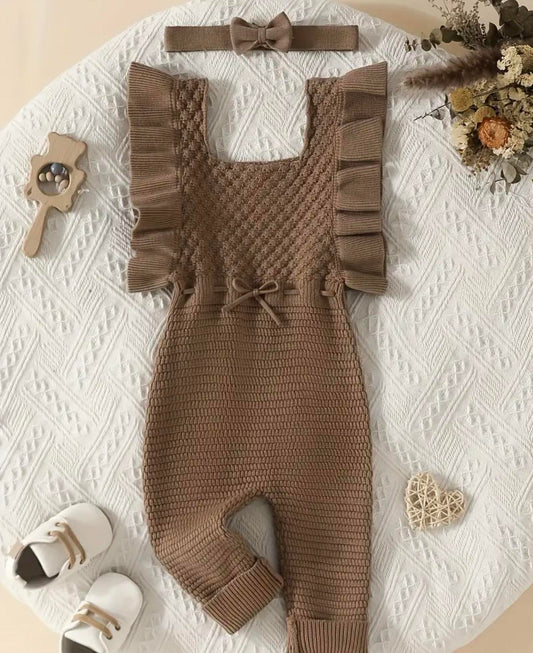 Baby wearing chocolate ruffle knit jumpsuit with matching headband