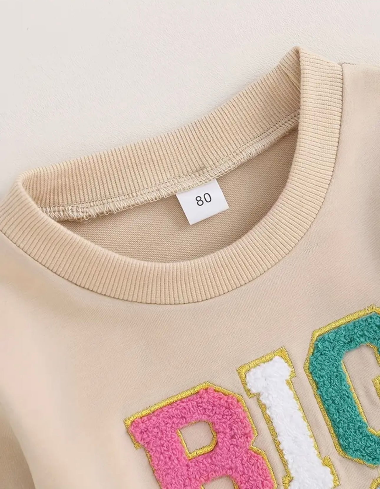 Beige Big Sis Pullover with bright, embroidered letters on the front, ideal for making big sisters feel special.