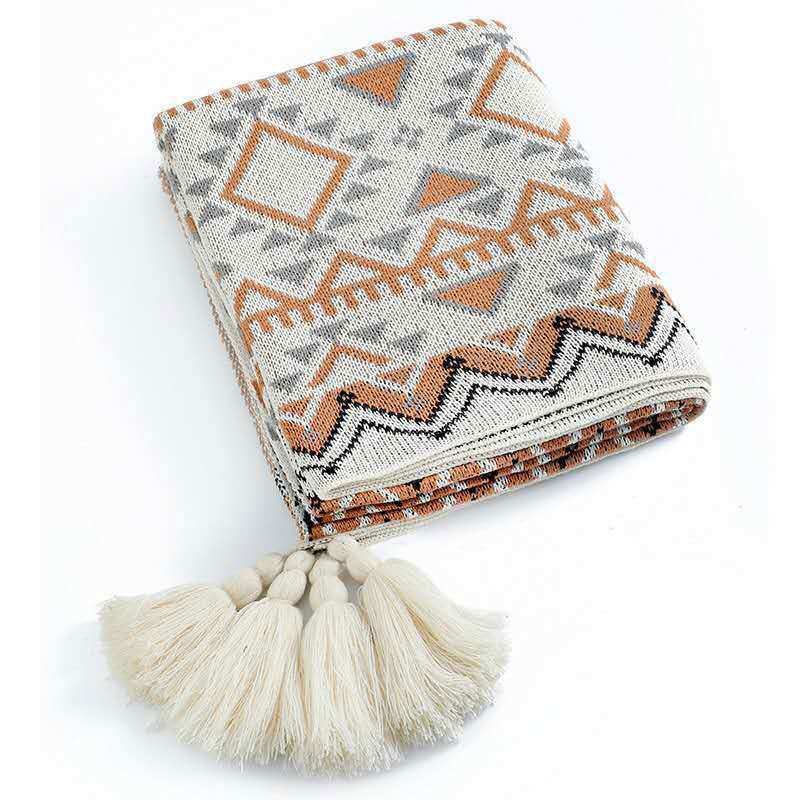 Discover the Oat White Boho Throw – a versatile, soft knitted blanket with tassel ends