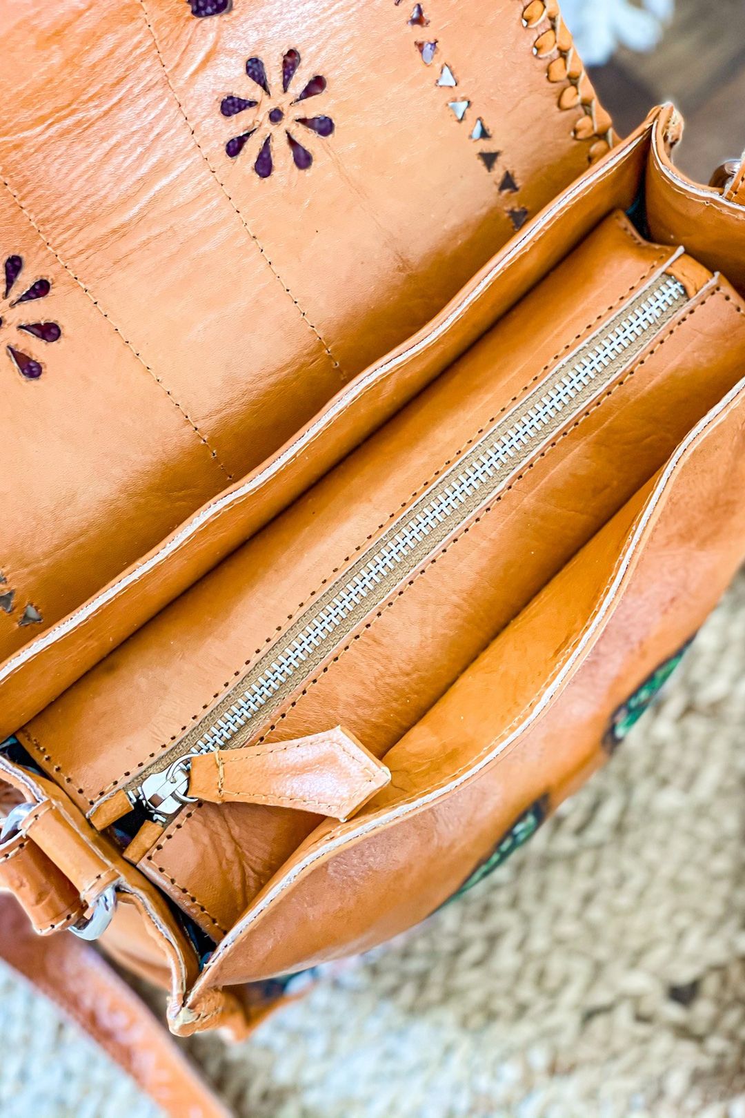 Close-up of the Daisy Mae Hand Painted Bag showing the intricate hand-tooled detailing and the vibrant rose design.