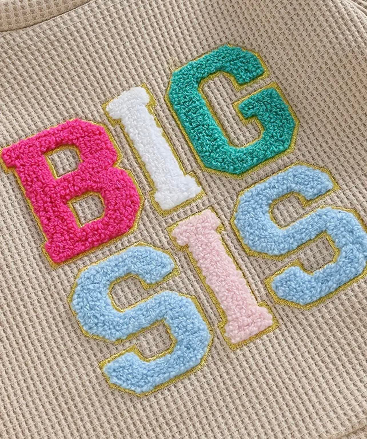 Colourful 'Big Sis' Two Piece Tracksuit for baby and toddler girls, featuring embroidered lettering and cozy waffle knit joggers.