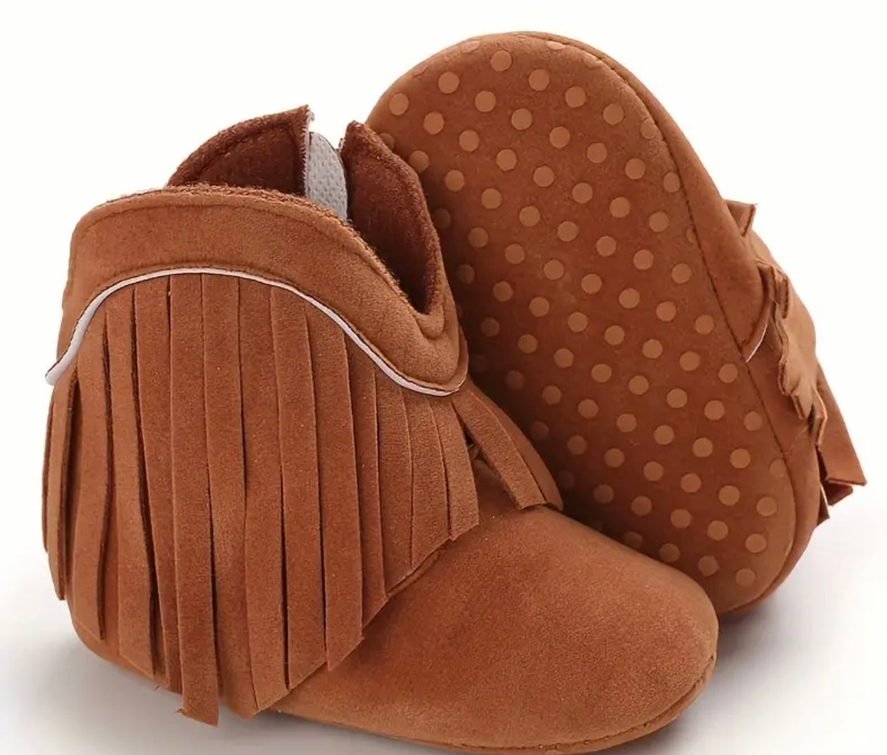 Cosy cowboy baby boots in soft plush material with cute tassels. Available in Beige, Pink, Brown, and Dark Grey, perfect for infants and toddlers.