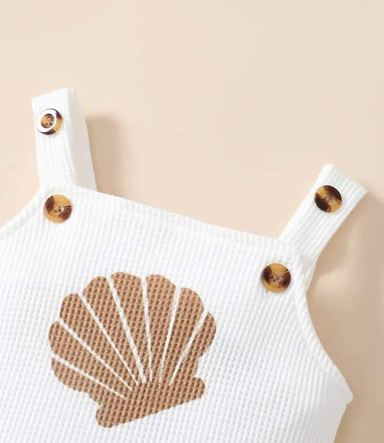 Cozy seashell-patterned baby outfit in soft knit, ideal for playdates and special events.