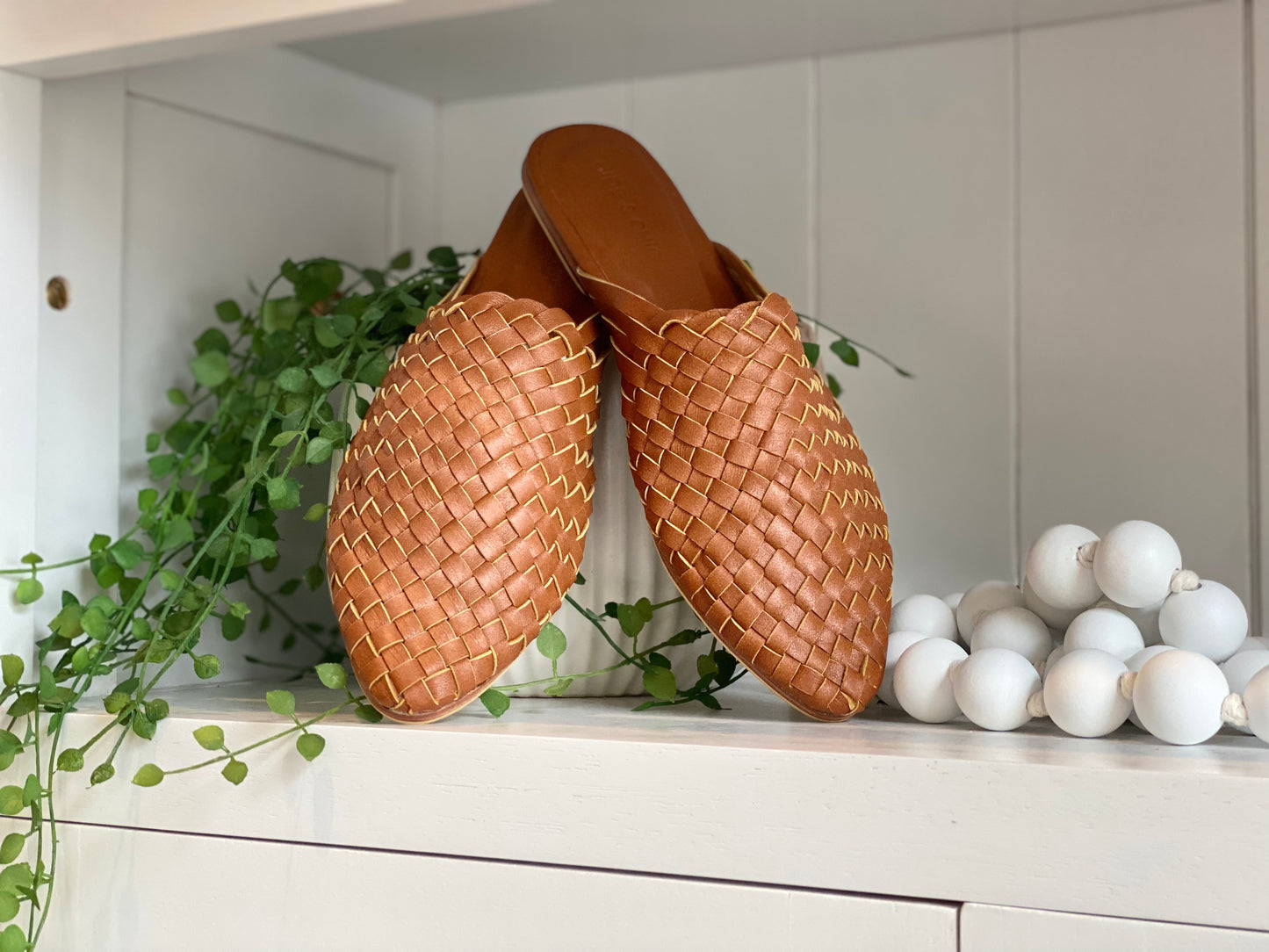 Dark Biscuit leather mule sandals with a pointed toe and closed toe woven design, featuring a slim fit and non-slip rubber sole, ideal for a stylish boho-chic look.