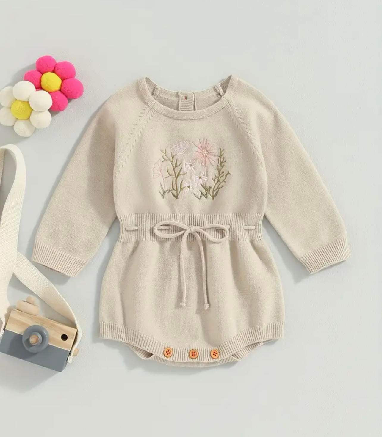 Trendy baby bodysuit with intricate embroidery and button closure