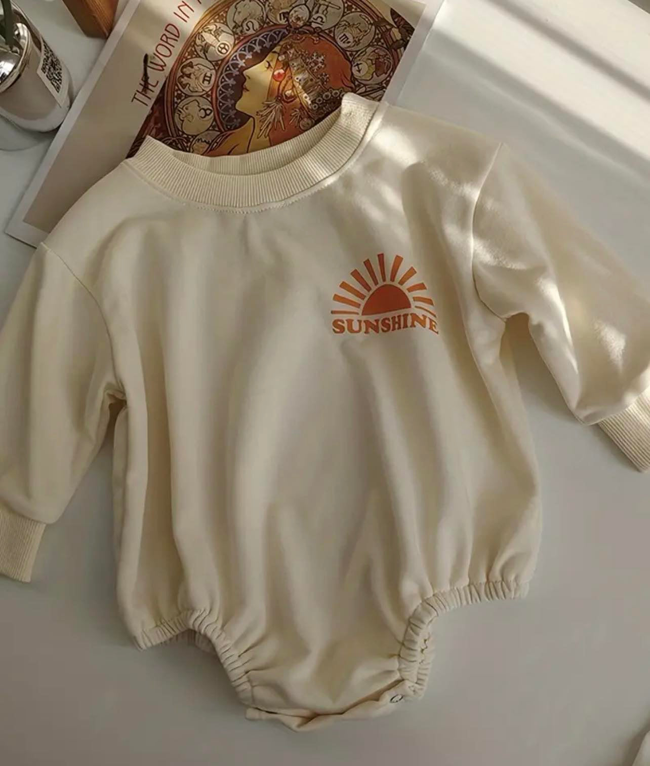 Discover the Here Comes The Sun Bubble Sleeve Romper, a stylish and comfy choice for your little one. Made from 100% soft cotton