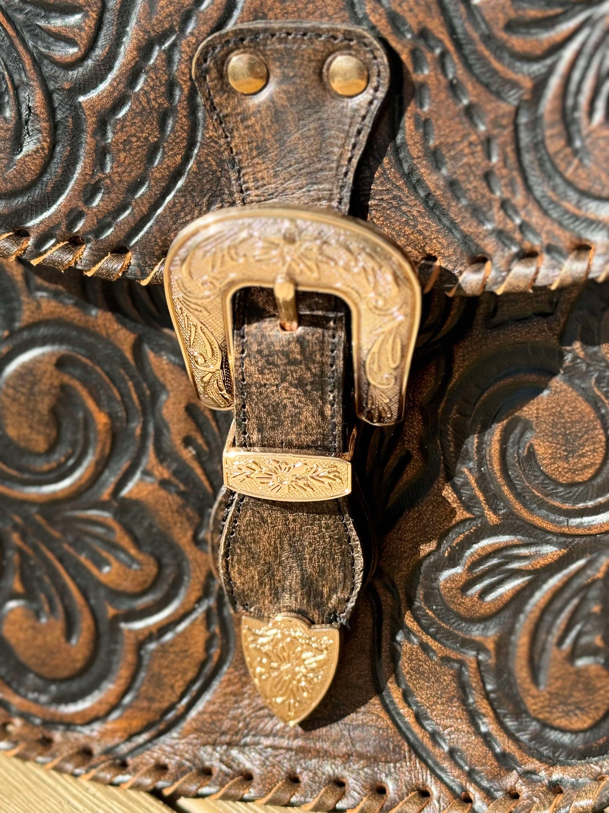 Indie Sky boho leather crossbody bag with hand-tooled detailing, adjustable strap, and magnetic closure, crafted from genuine antique brown leather.