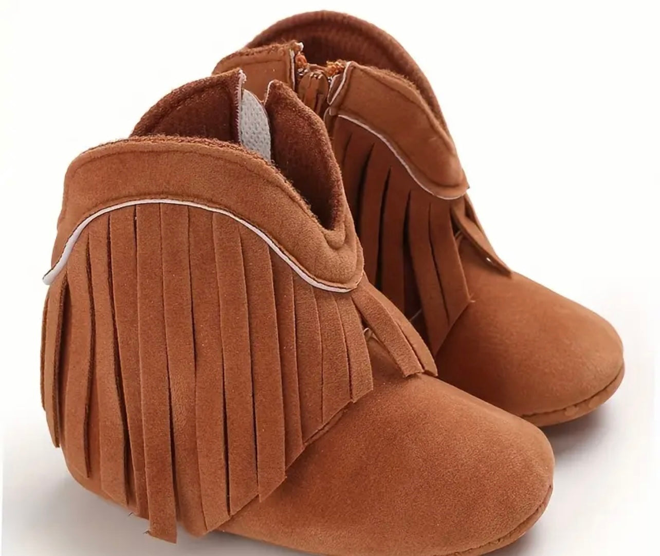 Soft cowboy baby boots for infants with plush material, tassels, and fringe details. Available in Beige, Pink, Brown, and Dark Grey, ideal for boys and girls