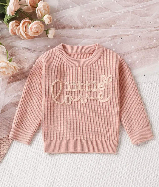 The Little Love Knot Knit Sweater for toddlers, featuring a round neck, long sleeves, and letter embroidery. Made from a soft blend of viscose and polyamide, this pullover is designed to keep your little one warm and stylish.