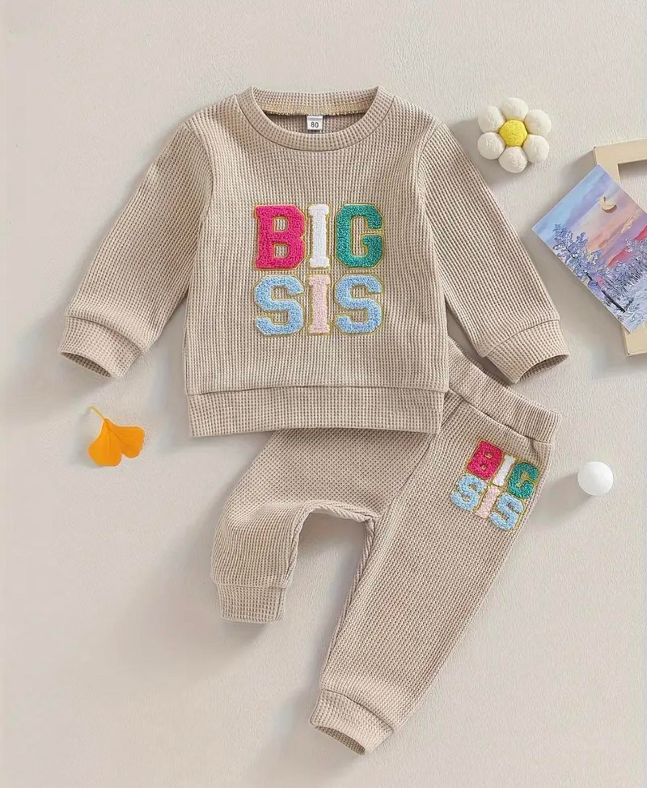 Waffle knit 'Big Sis' Tracksuit for baby and toddler girls, with colorful embroidery and matching joggers for a comfortable, playful look